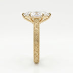 Side profile of marquise diamond engagement ring showing elevated setting and detailed gold engraving