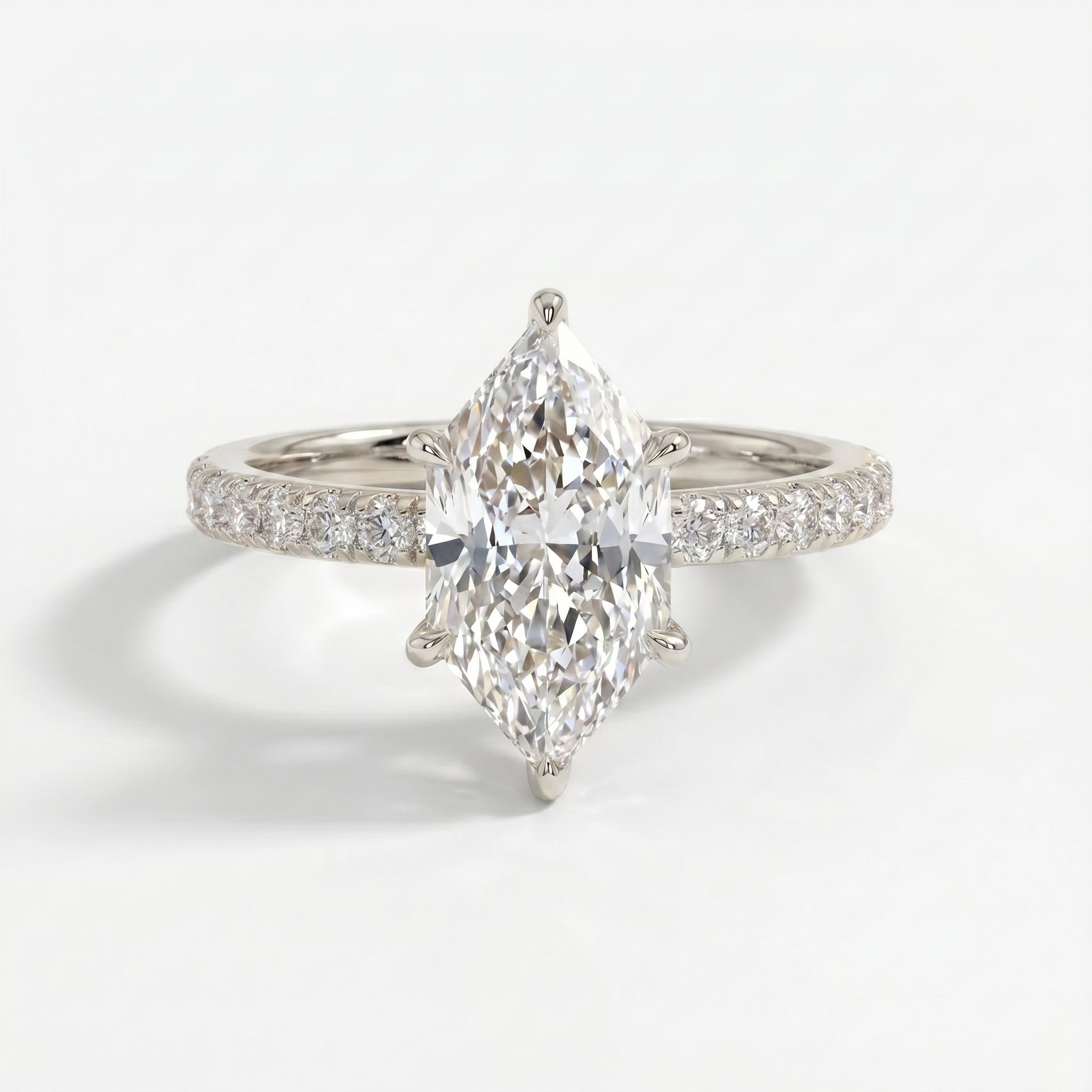 Marquise diamond engagement ring in white gold with pavé diamond band and luxury bridal design