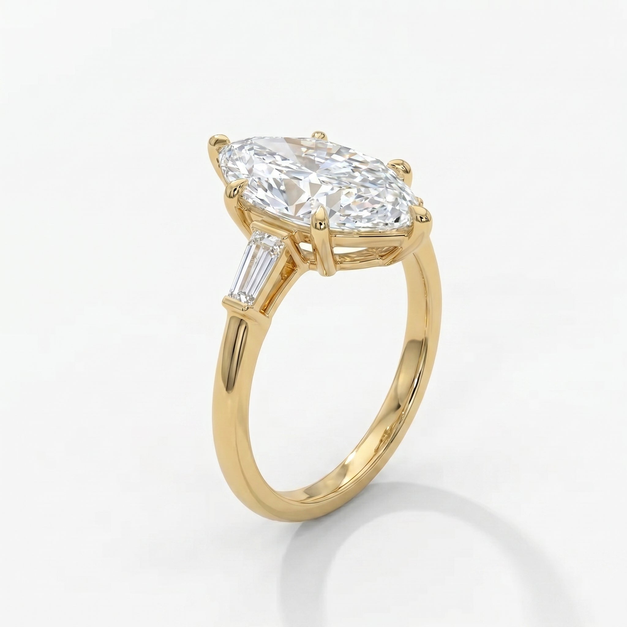 Luxury marquise cut diamond ring in yellow gold showing baguette accents from elegant 45 degree angle