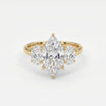 Marquise diamond three-stone engagement ring with oval side diamonds in polished yellow gold setting