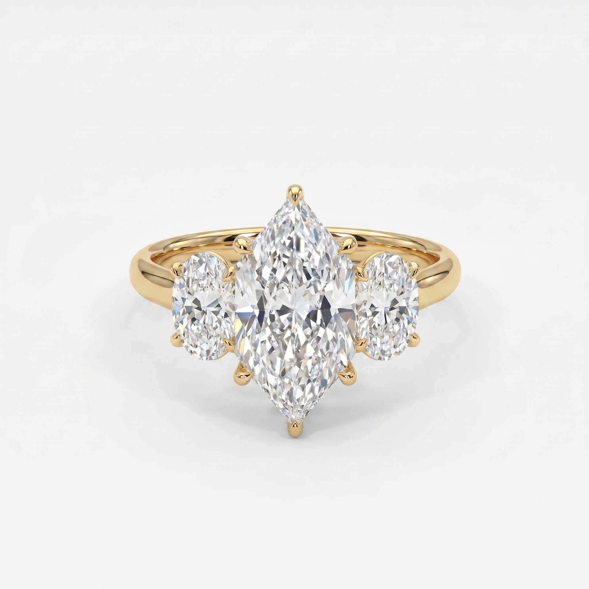 Marquise diamond three-stone engagement ring with oval side diamonds in polished yellow gold setting