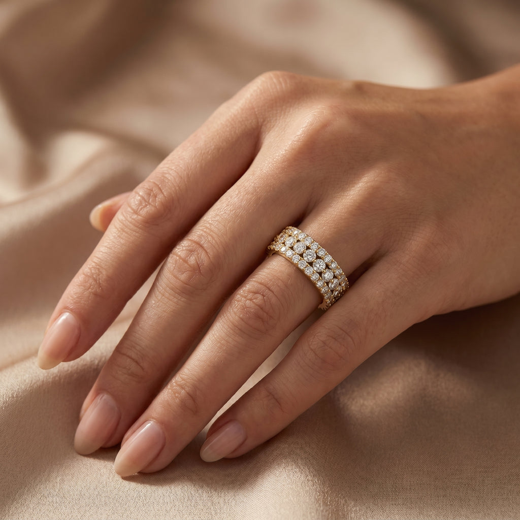 Multi-row round diamond band ring in yellow gold with pavé setting and brilliant sparkle on white background