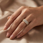Multi-row round diamond band ring in yellow gold with pavé setting and brilliant sparkle on white background