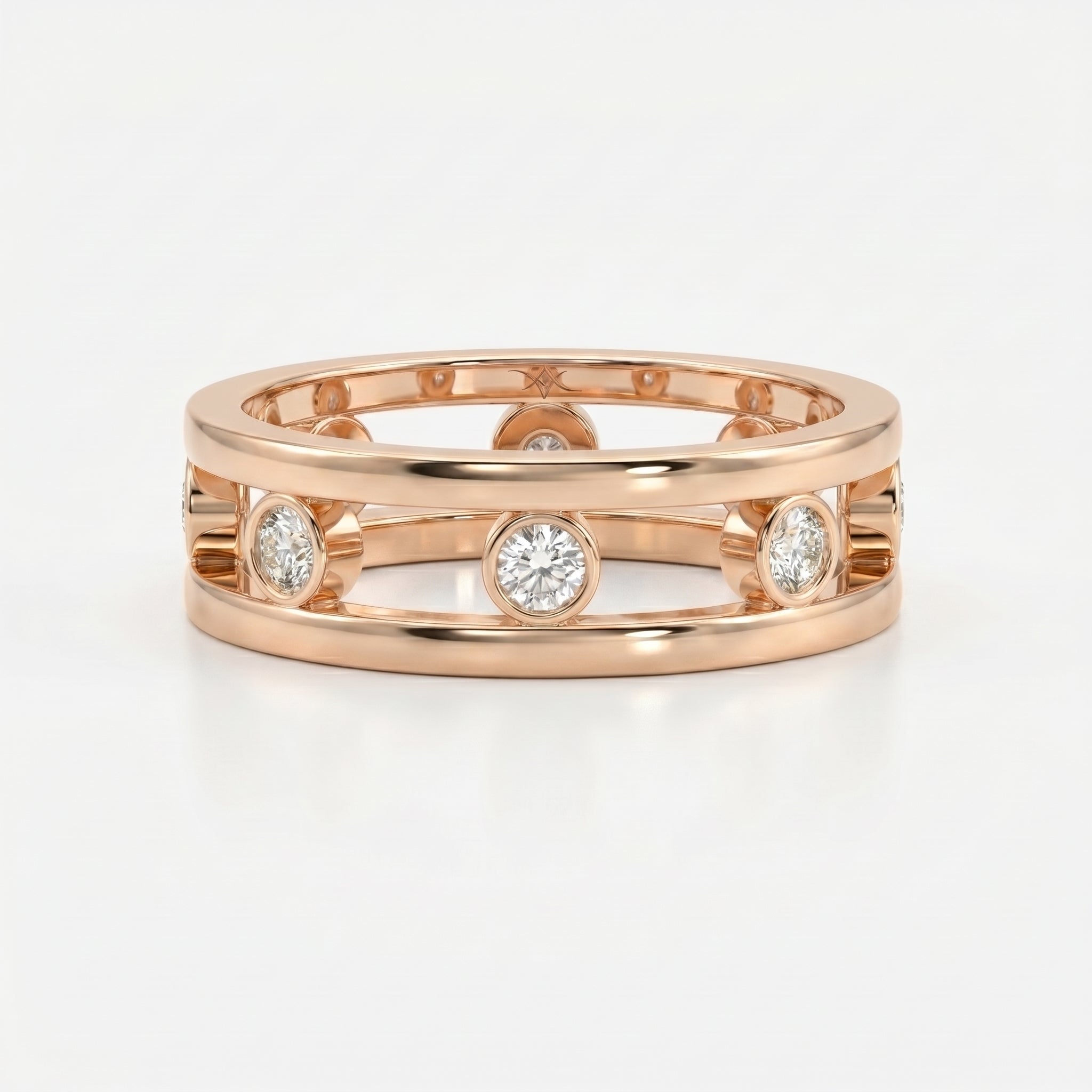 Architectural diamond band ring featuring bezel set round diamonds and open gallery design in polished metal