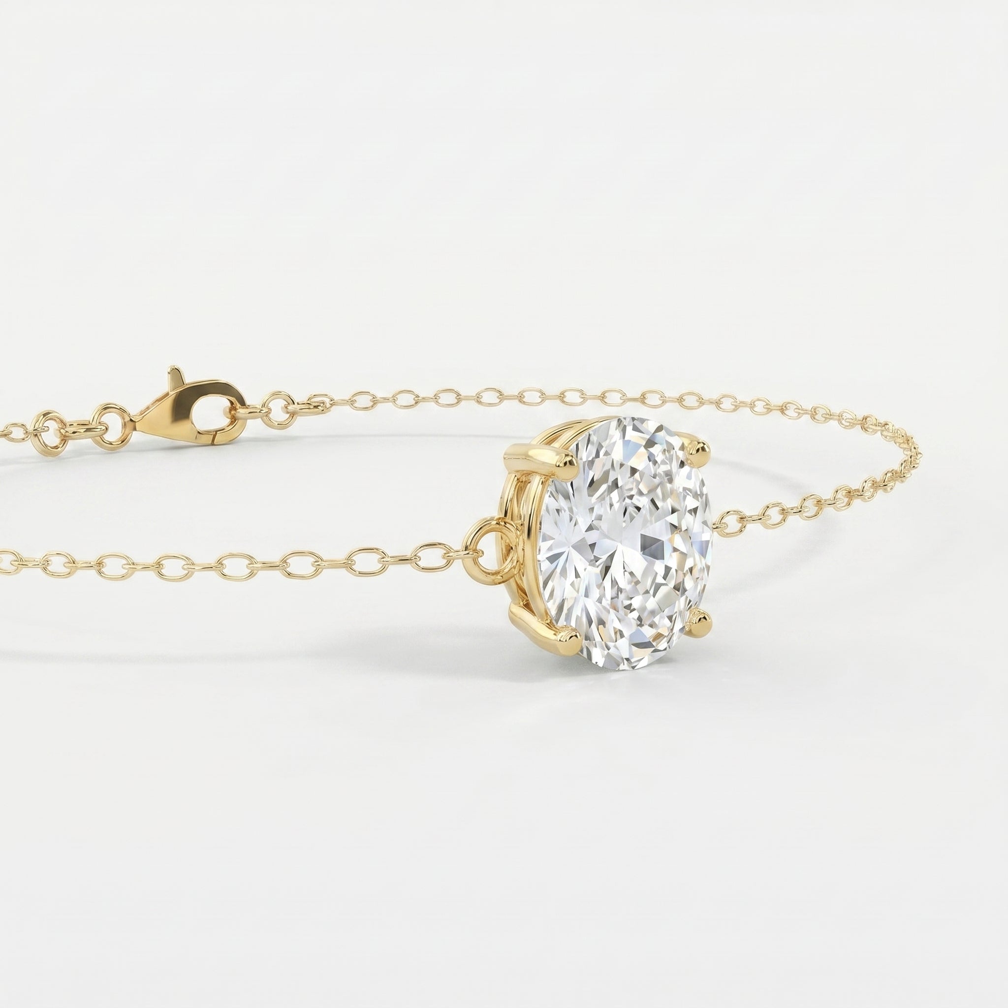 Luxury oval diamond bracelet in yellow gold shown at 45-degree angle with elegant sparkle and fine chain
