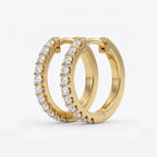 Macro detail of pavé-set round diamonds on luxury rose gold huggie hoop earrings with brilliant sparkle
