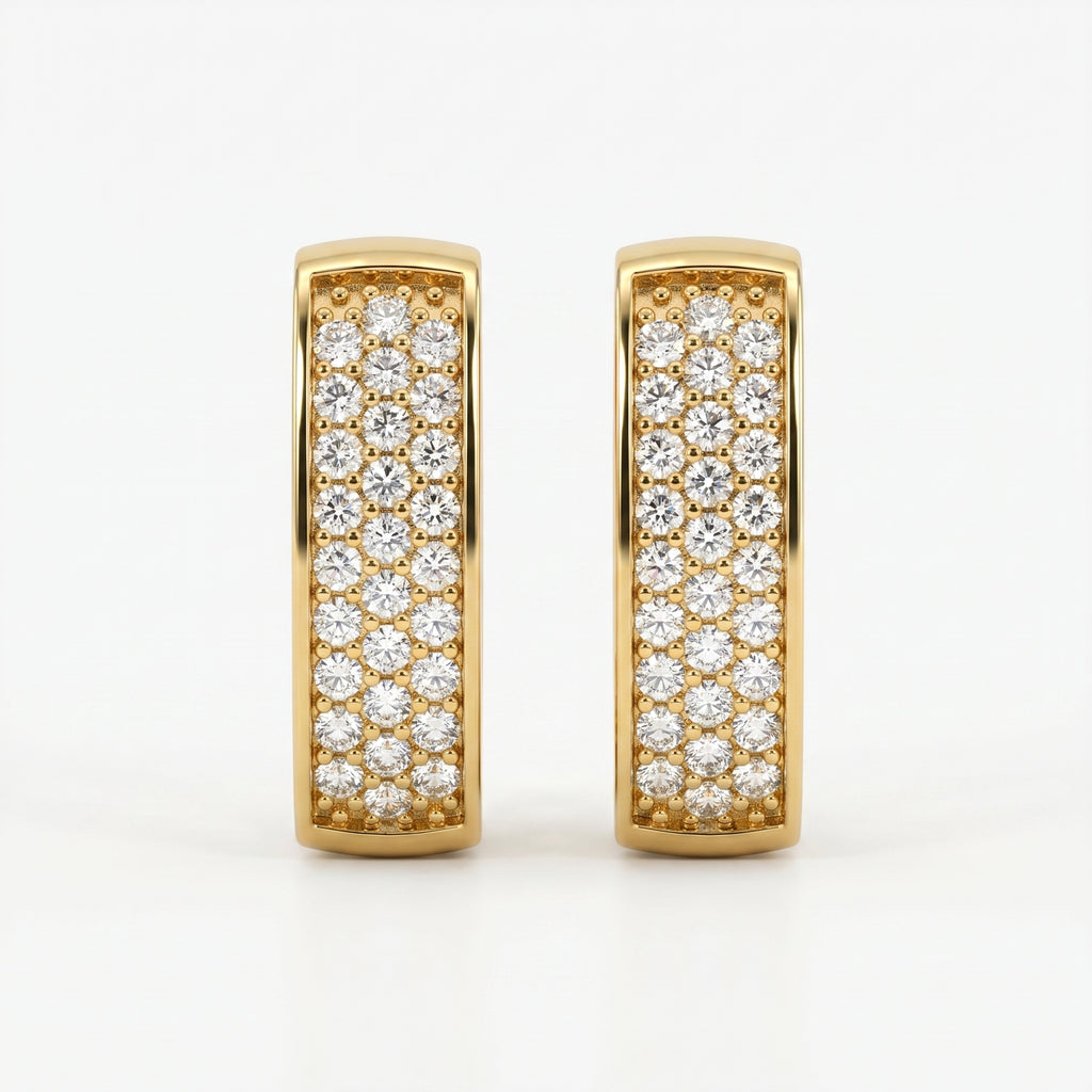 Yellow gold and silver pavé huggie earrings comparison with sparkling stones on white background