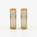Yellow gold and silver pavé huggie earrings comparison with sparkling stones on white background
