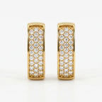 Yellow gold and silver pavé huggie earrings comparison with sparkling stones on white background