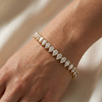 Pear cut diamond tennis bracelet in yellow gold with continuous sparkling stones and secure box clasp