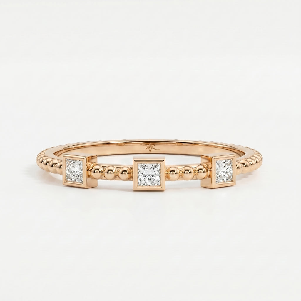 Close-up of princess-cut diamonds and beaded gold texture showing sparkle, craftsmanship and luxury detail