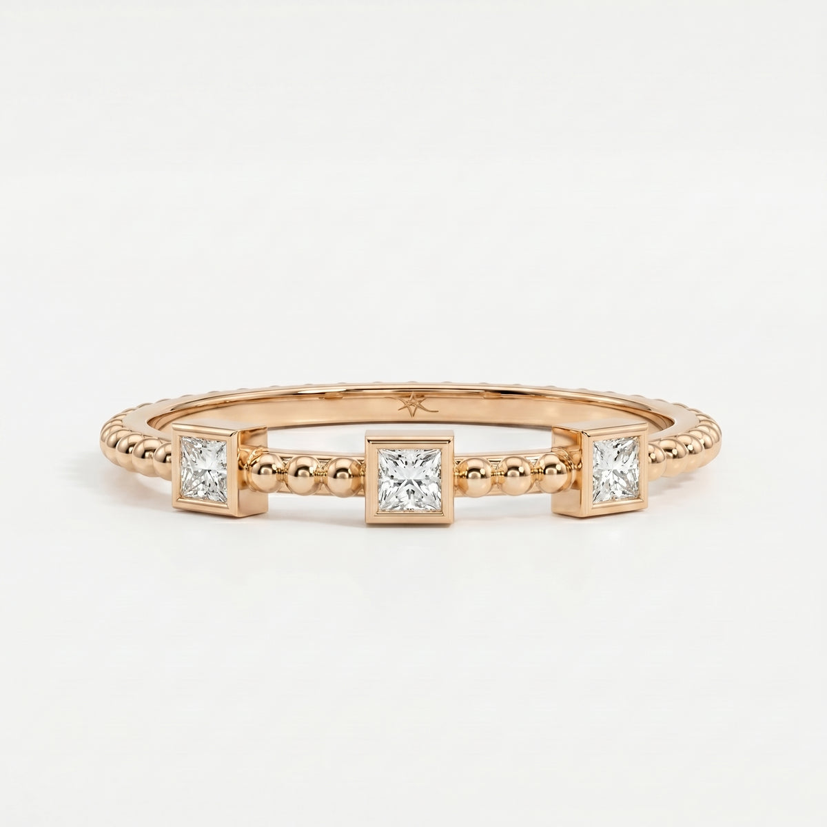Close-up of princess-cut diamonds and beaded gold texture showing sparkle, craftsmanship and luxury detail