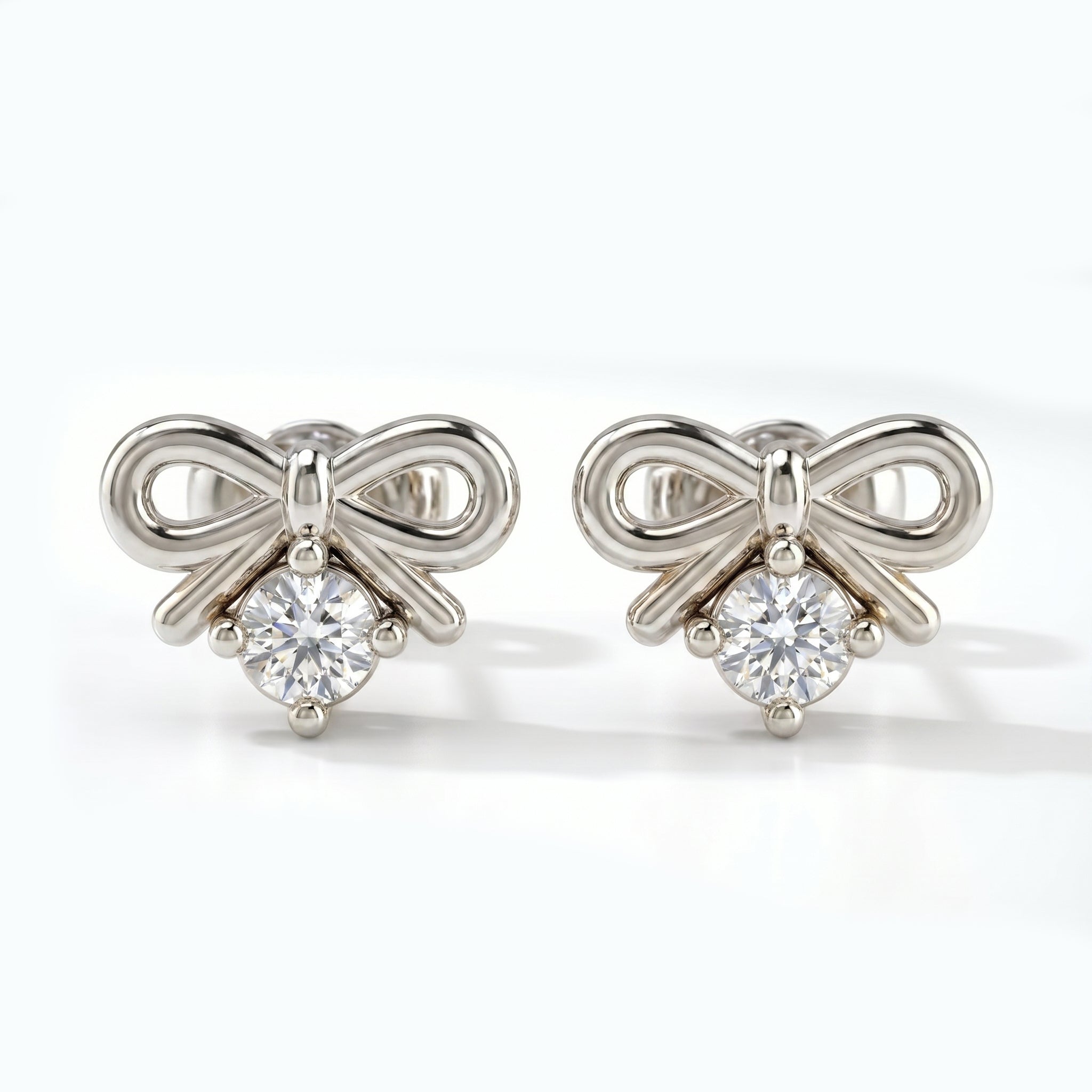 Luxury rose gold bow earrings with sparkling round stone shown at 45 degree angle on white background