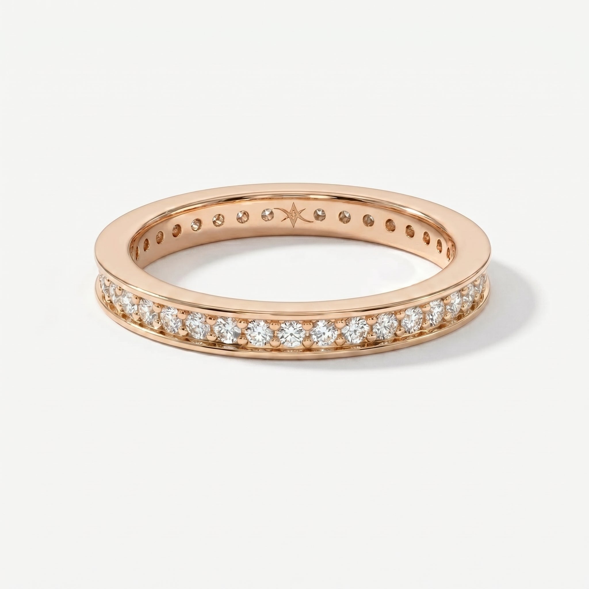 Rose gold diamond eternity band ring with round brilliant diamonds in a sleek shared-prong setting.