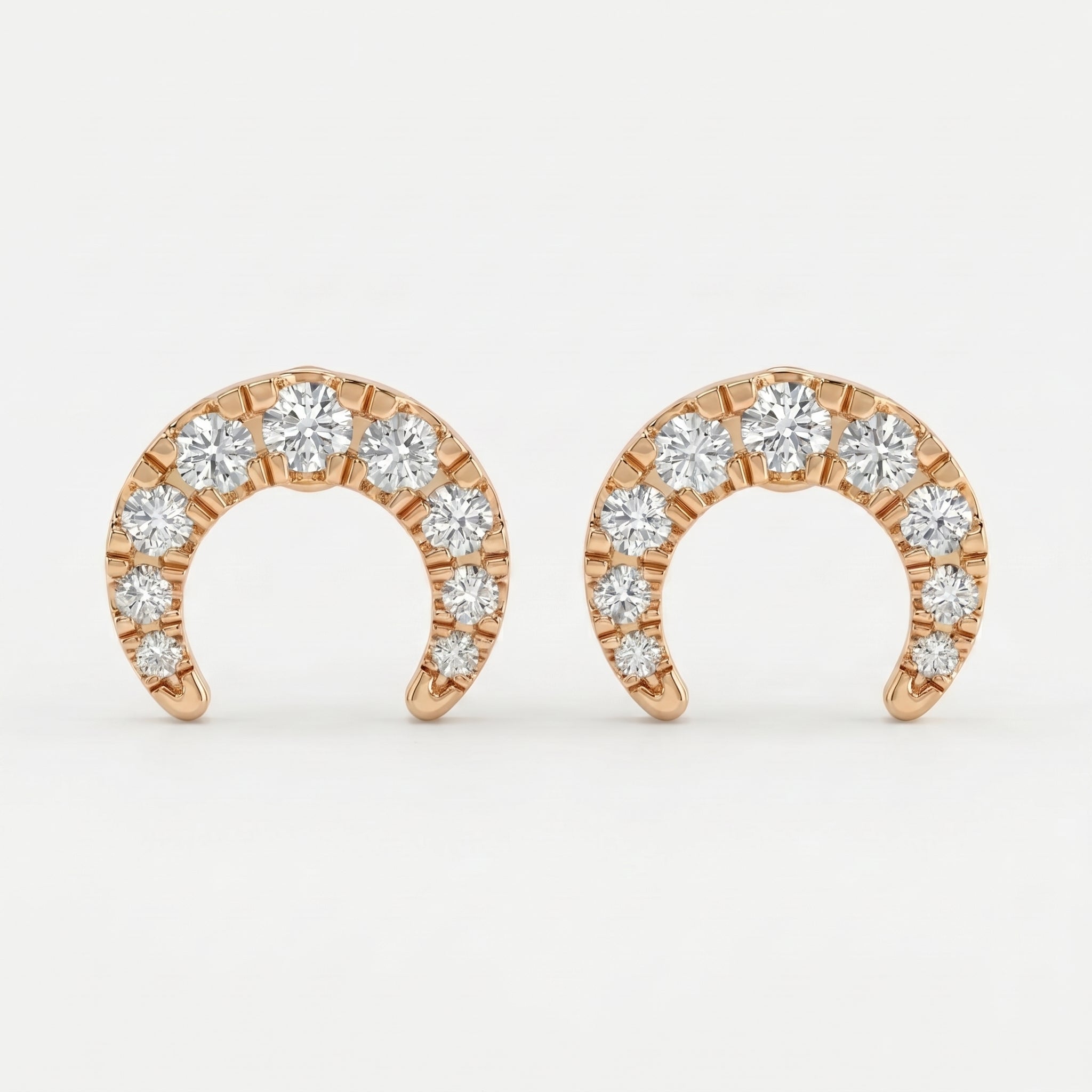 Rose gold horseshoe stud earrings with round diamonds on white background, minimalist luxury jewelry design