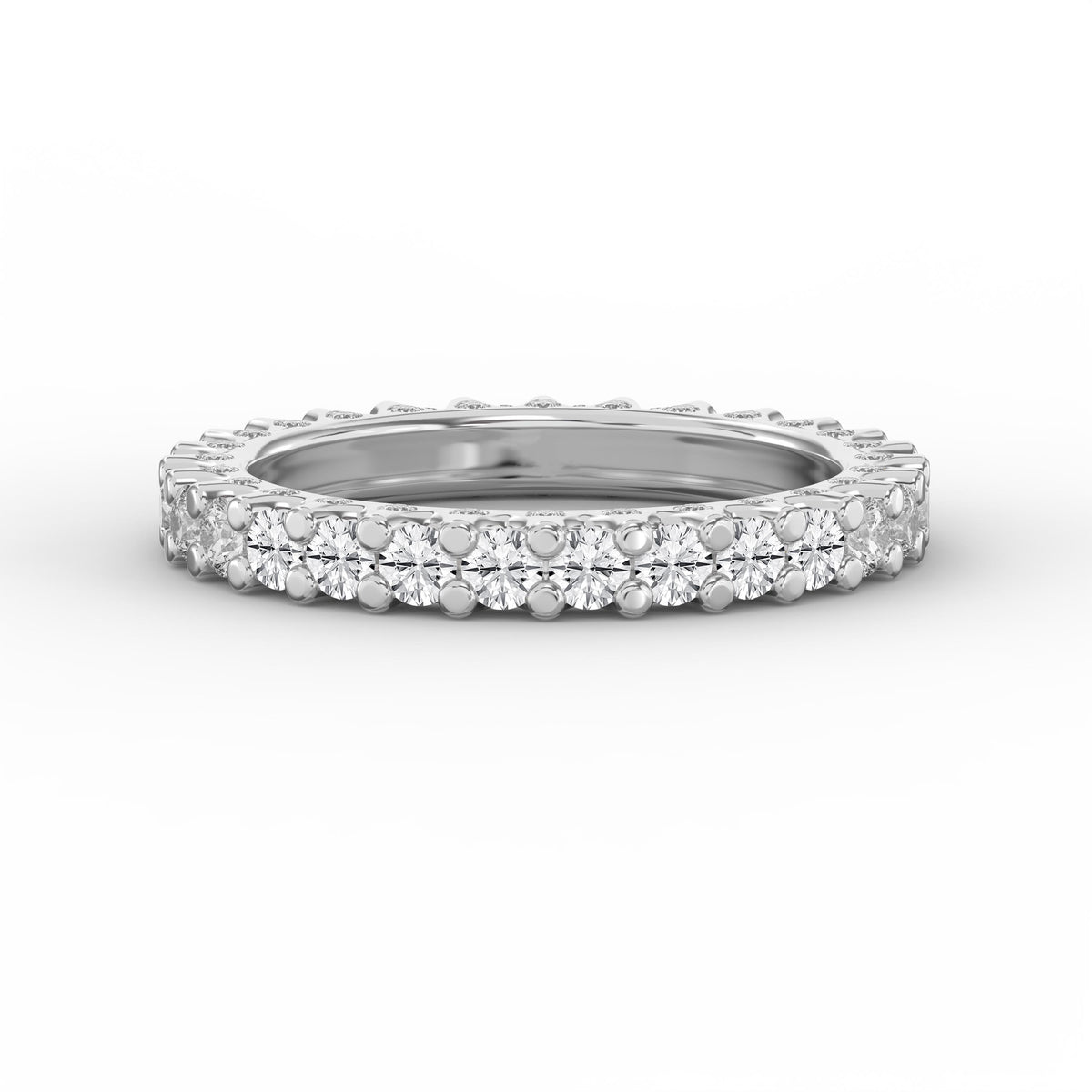 Round brilliant diamond eternity band in polished white gold with a shared prong setting on a clean white studio background.