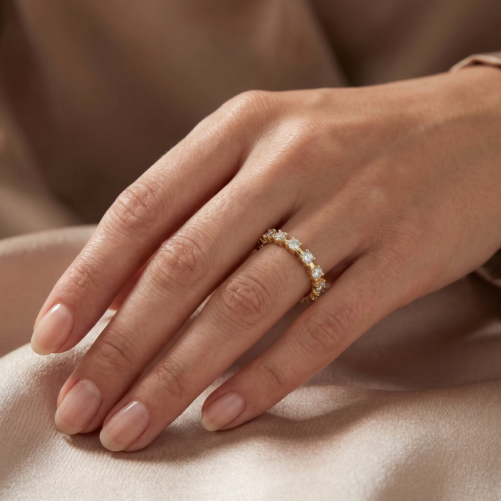 Round diamond eternity band in yellow gold with shared prong setting and brilliant lab grown diamonds.