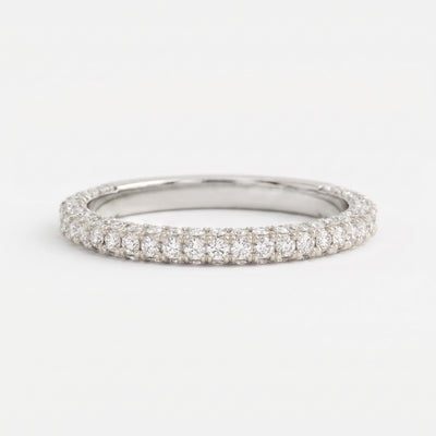 Round brilliant diamond eternity wedding band in polished white gold with shared prong setting on a clean white background.