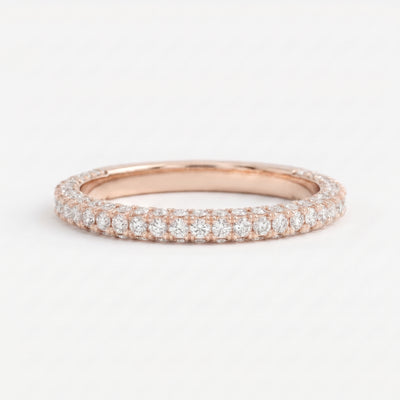 Round brilliant diamond eternity wedding band in polished Rose gold with shared-prong setting, stackable fine jewelry for weddings and anniversaries.