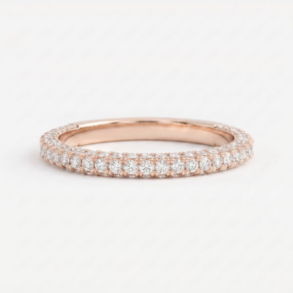 Round brilliant diamond eternity wedding band in polished Rose gold with shared-prong setting, stackable fine jewelry for weddings and anniversaries.