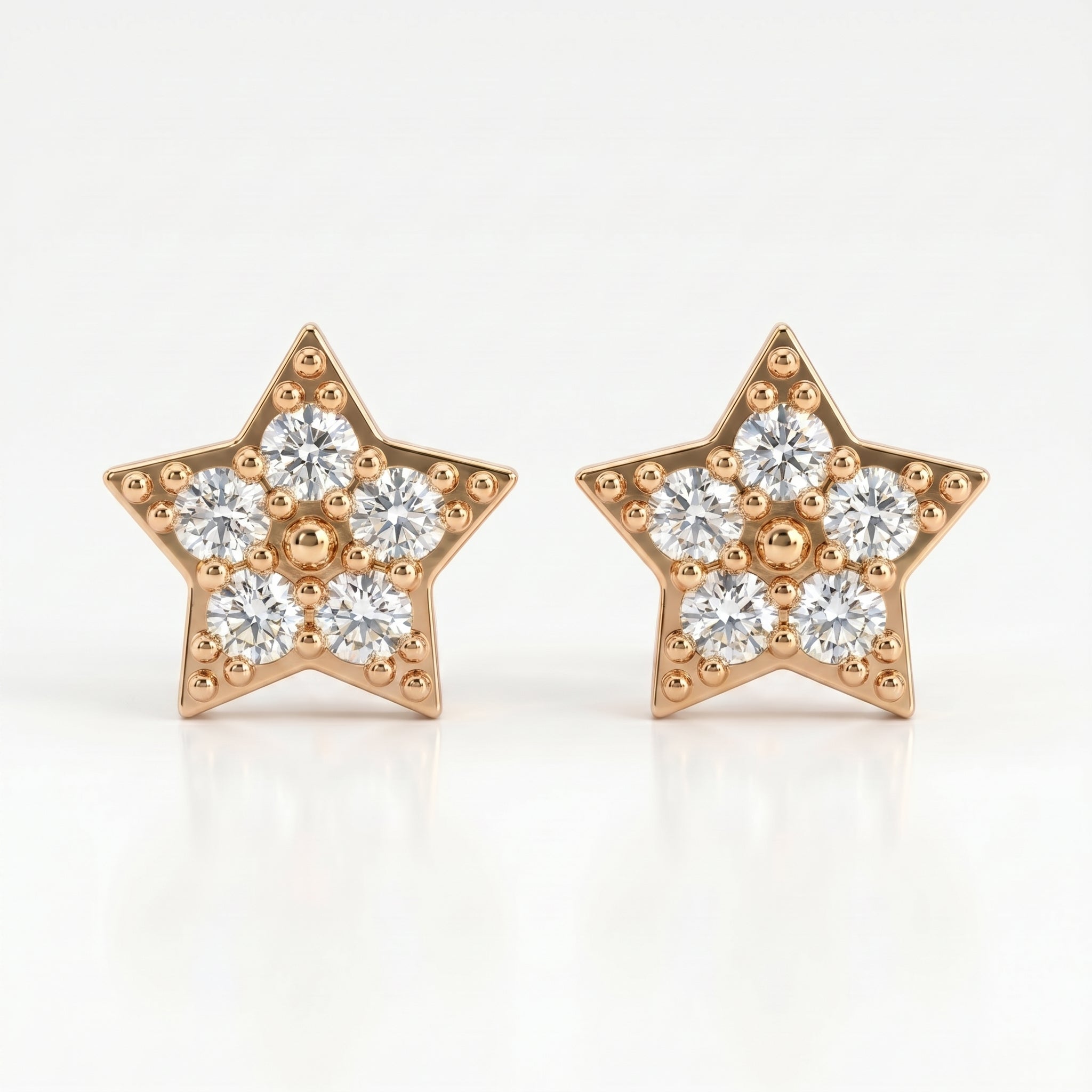 Gold star-shaped diamond stud earrings with pavé stones on white background, minimalist luxury jewelry design