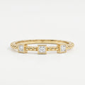 Three princess-cut diamond beaded yellow gold ring with modern bezel settings and minimalist luxury design
