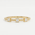 Three princess-cut diamond beaded yellow gold ring with modern bezel settings and minimalist luxury design