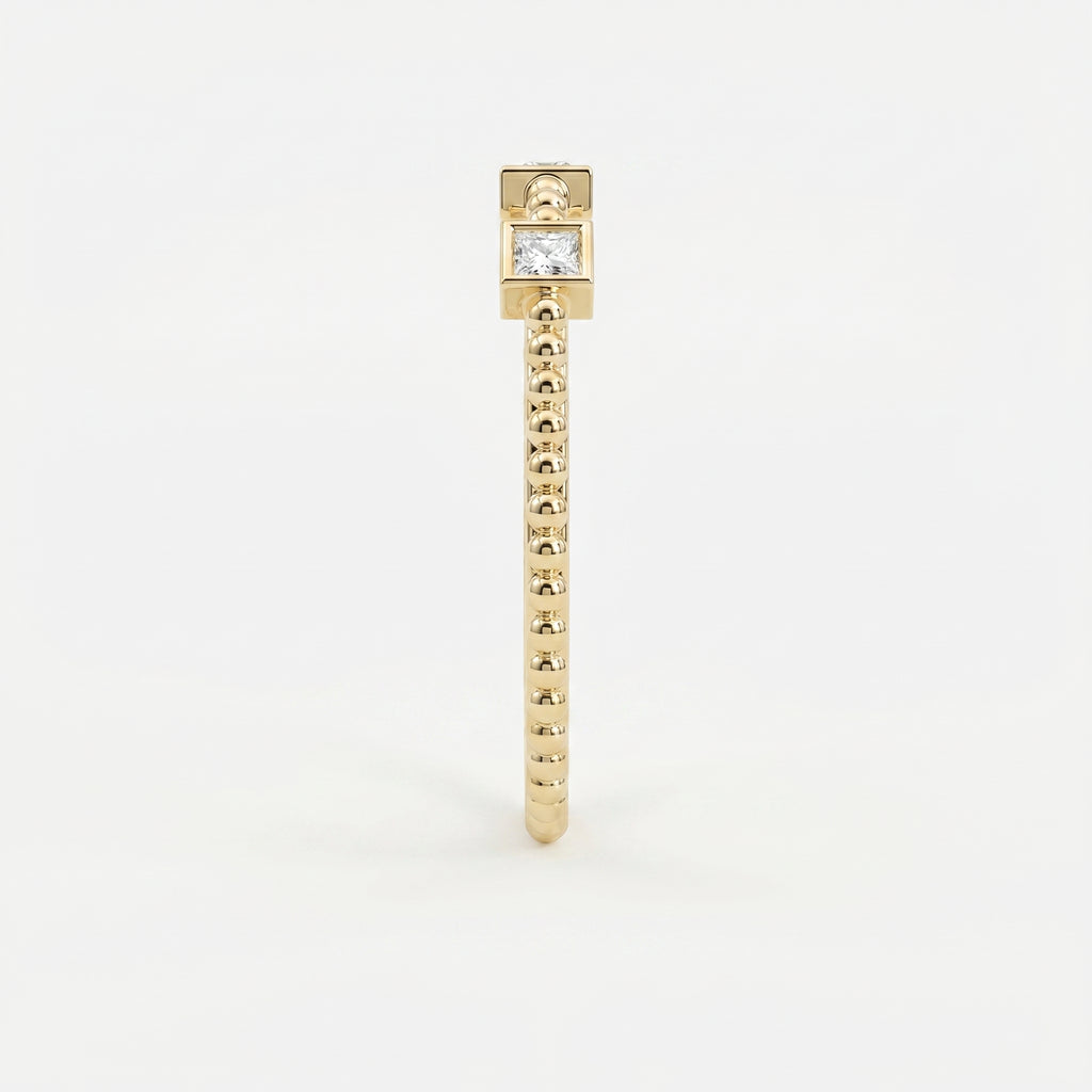 Side profile of yellow gold diamond stacking ring showing low bezel settings and beaded band detail