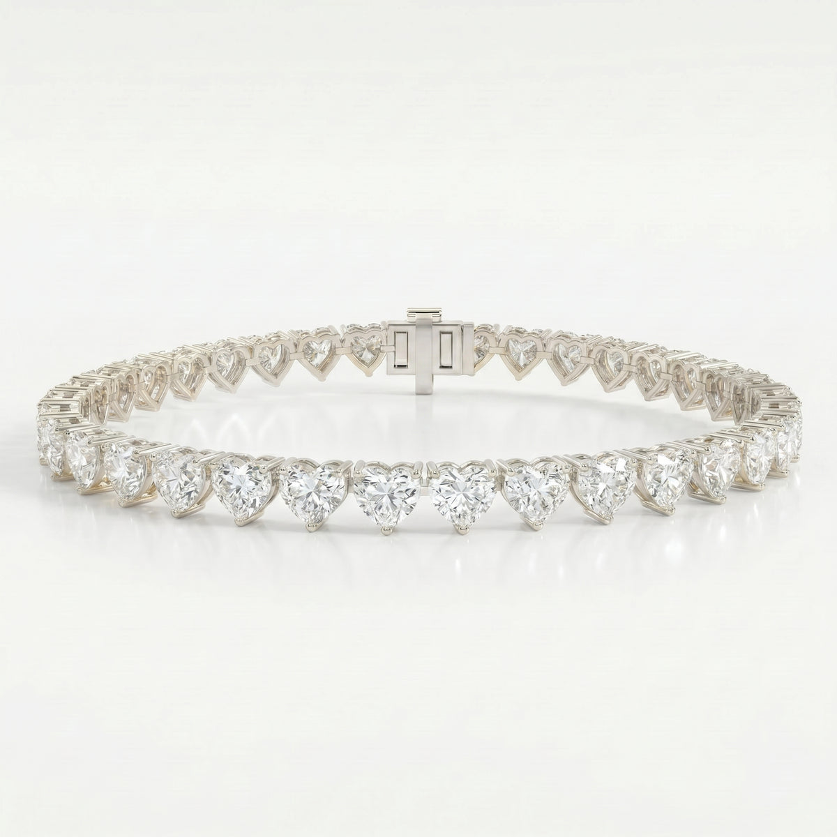 White gold heart-cut diamond tennis bracelet featuring brilliant stones, elegant craftsmanship and secure clasp.