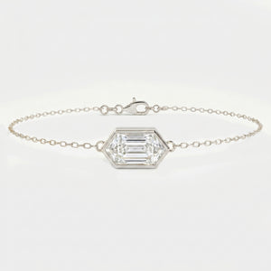 White gold hexagon diamond bracelet with emerald step cut gemstone on delicate minimalist chain