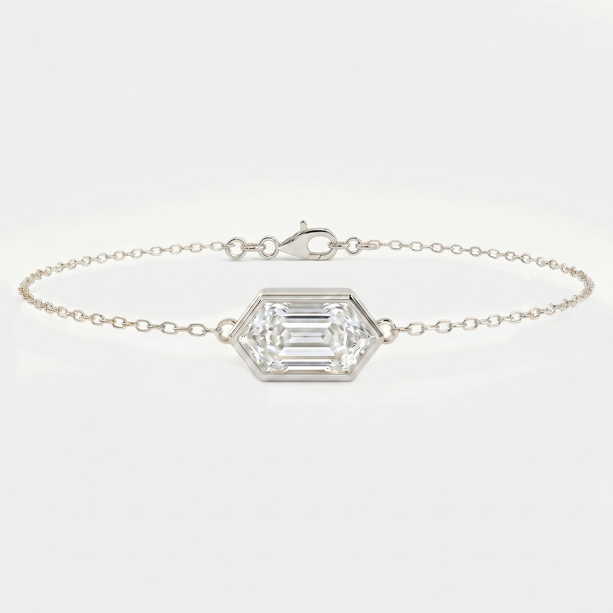 White gold hexagon diamond bracelet with emerald step cut gemstone on delicate minimalist chain