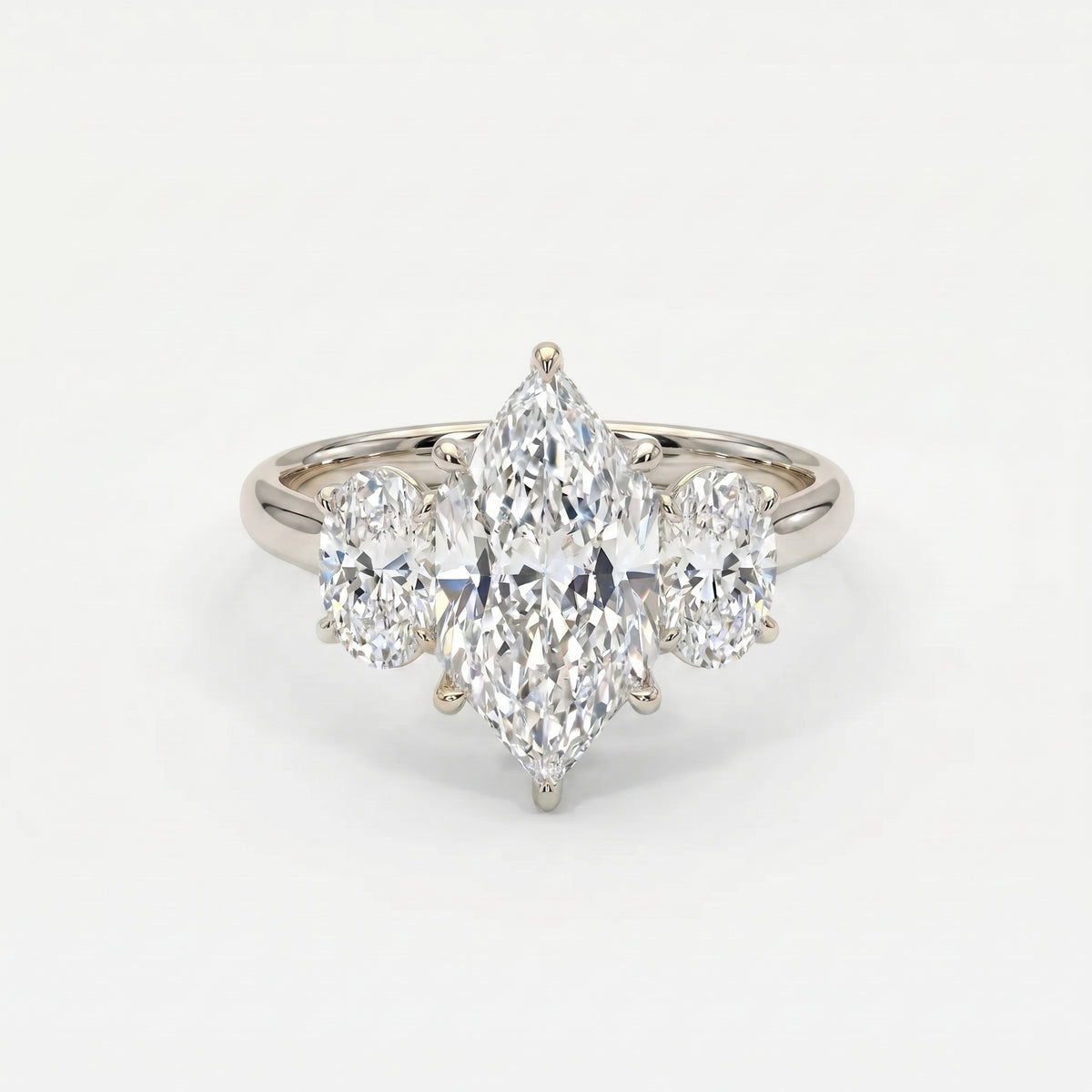 White gold marquise cut three stone engagement ring with oval side diamonds and elegant polished setting