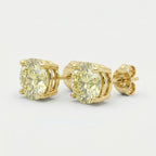 Luxury yellow diamond stud earrings in polished yellow gold with round-cut stones and four-prong basket setting