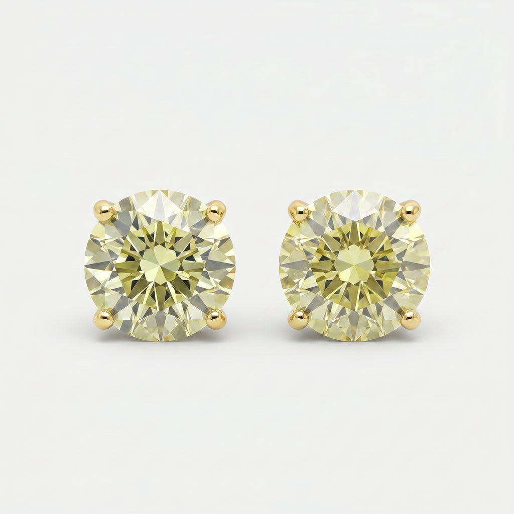 Round yellow diamond stud earrings in yellow gold setting on white background with brilliant sparkle and luxury finish