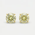 Round yellow diamond stud earrings in yellow gold setting on white background with brilliant sparkle and luxury finish