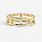 Luxury yellow gold open band ring featuring bezel-set Emerald diamonds and modern geometric architectural design.