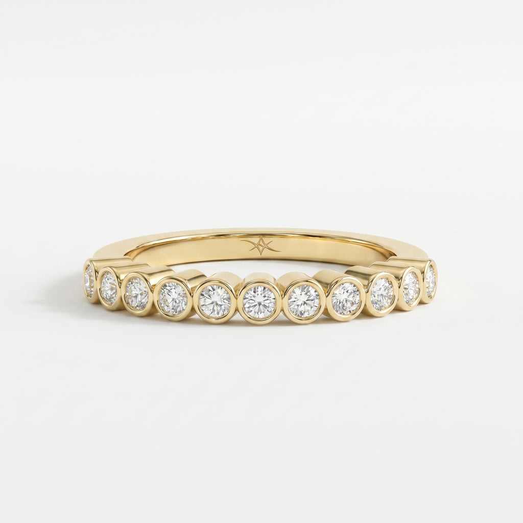 Yellow gold bezel-set diamond eternity ring with round brilliant diamonds, modern luxury wedding band design