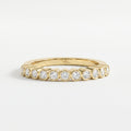 Yellow gold bezel-set diamond eternity ring with round brilliant diamonds, modern luxury wedding band design