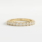 Yellow gold bezel-set diamond eternity ring with round brilliant diamonds, modern luxury wedding band design