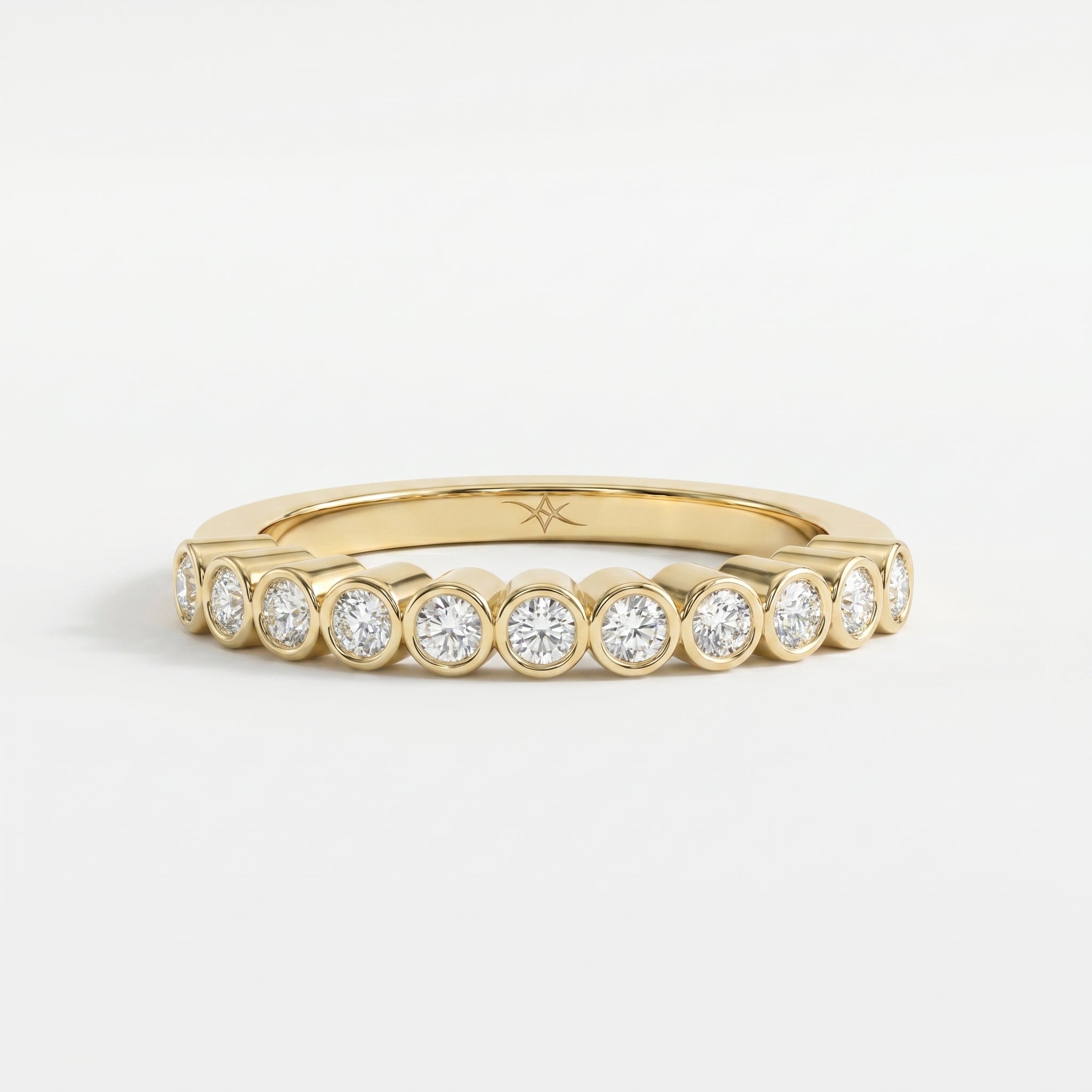 Yellow gold bezel-set diamond eternity ring with round brilliant diamonds, modern luxury wedding band design