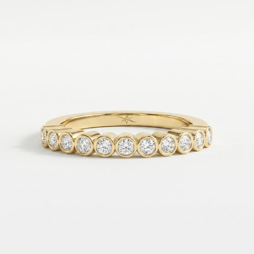 Yellow gold bezel-set diamond eternity ring with round brilliant diamonds, modern luxury wedding band design