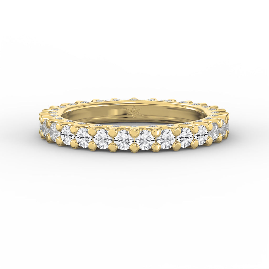 Yellow gold full eternity diamond ring with round brilliant diamonds in a shared prong setting on a pure white background.