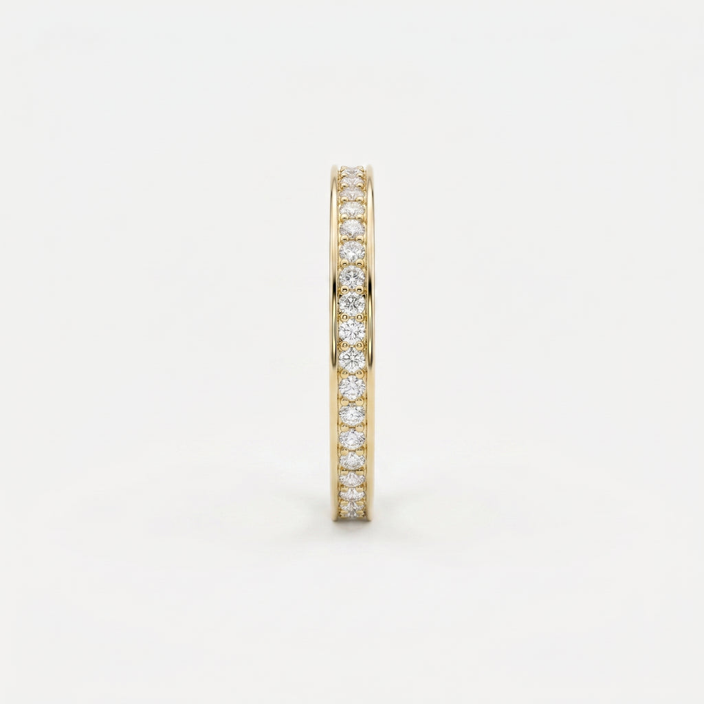 Side profile of yellow gold diamond eternity band showing slim width and secure diamond setting details