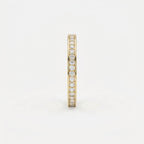 Side profile of yellow gold diamond eternity band showing slim width and secure diamond setting details