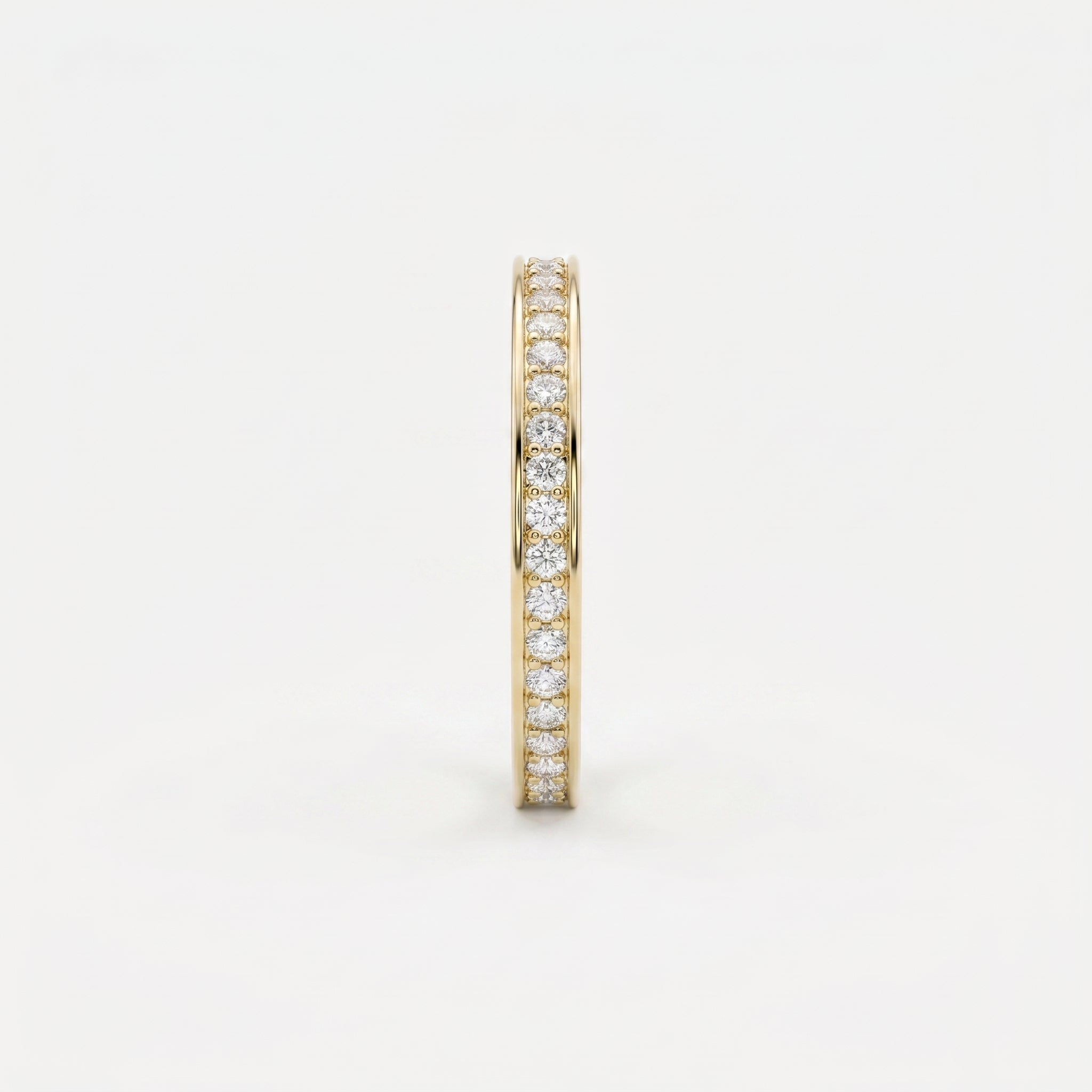 Side profile of yellow gold diamond eternity band showing slim width and secure diamond setting details