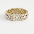 Yellow gold diamond eternity band with three rows of round brilliant diamonds on a pure white background