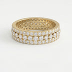 Yellow gold diamond eternity band with three rows of round brilliant diamonds on a pure white background