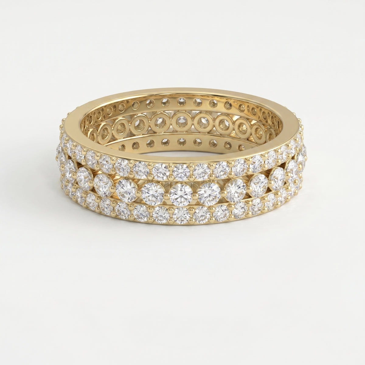 Yellow gold diamond eternity band with three rows of round brilliant diamonds on a pure white background