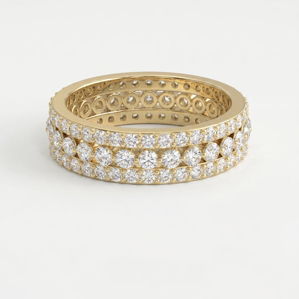 Yellow gold diamond eternity band with three rows of round brilliant diamonds on a pure white background