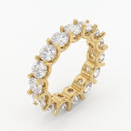 Luxury yellow gold eternity band featuring round brilliant diamonds in a shared-prong setting viewed at a 45-degree angle.